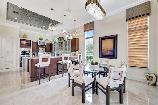 tiled dining area with a tray ceiling and an inviting chandelier