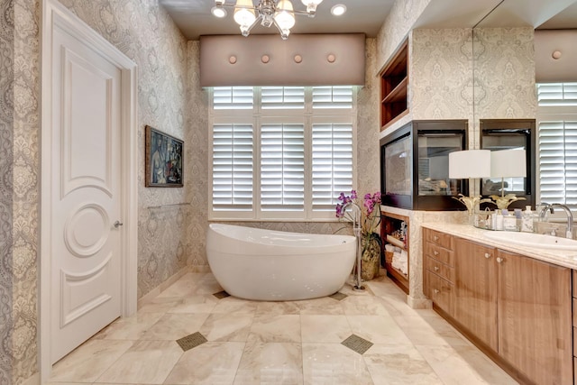 bathroom with a healthy amount of sunlight, tile flooring, and vanity