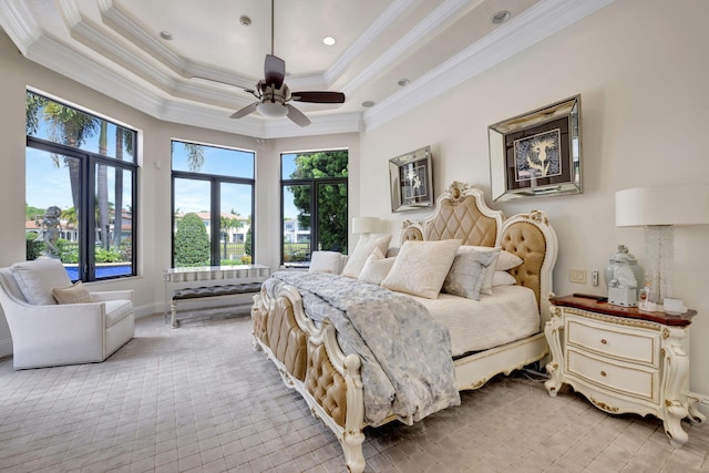 bedroom with a raised ceiling, ceiling fan, and ornamental molding