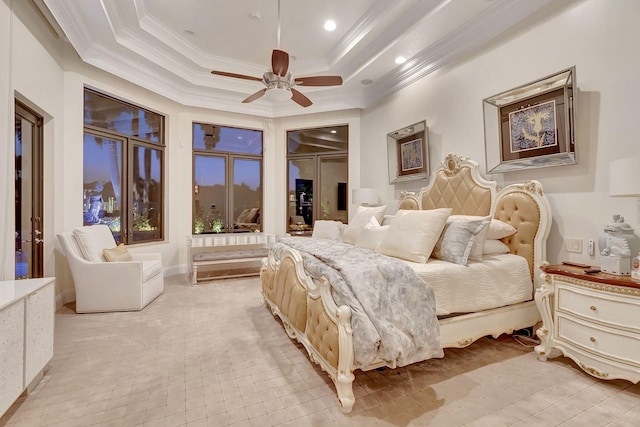 bedroom featuring a closet, ceiling fan, a raised ceiling, crown molding, and a spacious closet