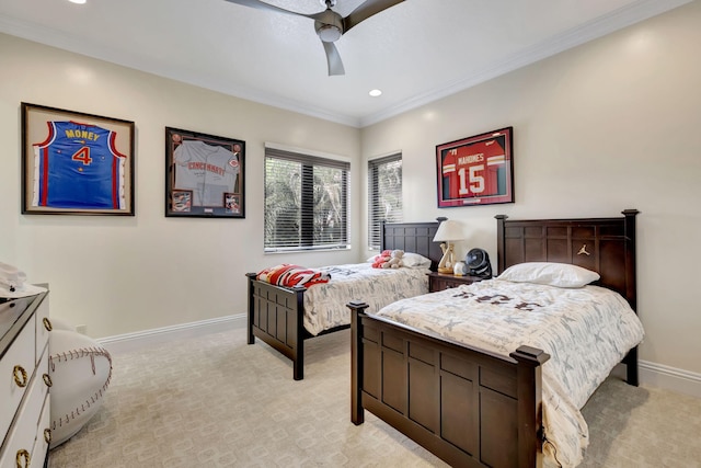 carpeted bedroom with ceiling fan and ornamental molding