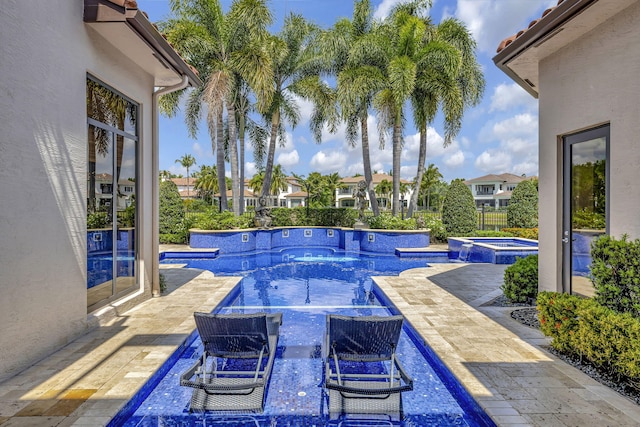 view of swimming pool with a patio and an in ground hot tub