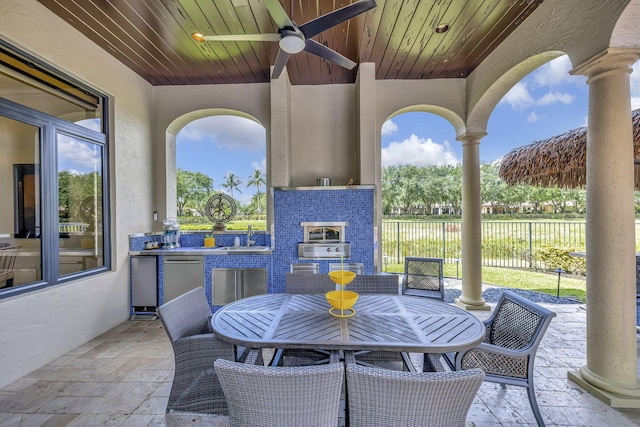 view of patio featuring exterior kitchen, ceiling fan, and sink