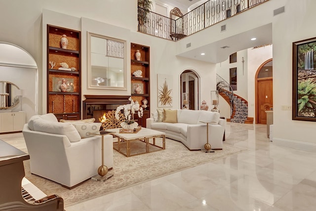 interior space with built in shelves, a towering ceiling, and light tile floors