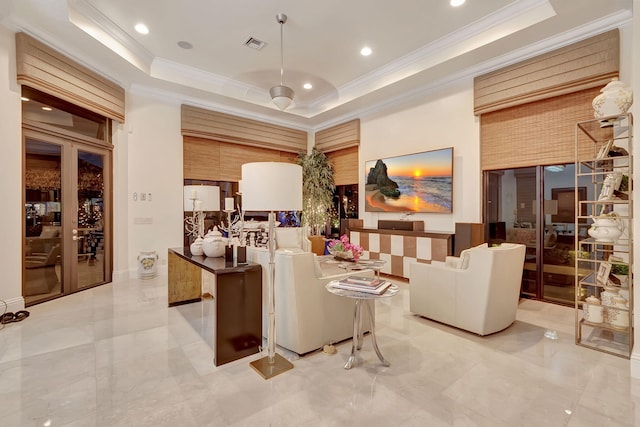 living room with crown molding, light tile floors, and a tray ceiling