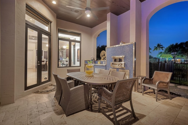 patio terrace at twilight featuring ceiling fan