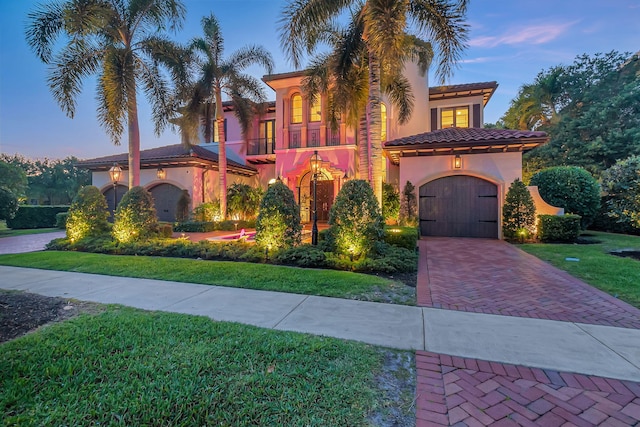 mediterranean / spanish house featuring a lawn