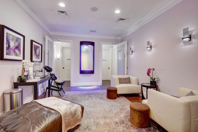 sitting room with wood-type flooring and crown molding