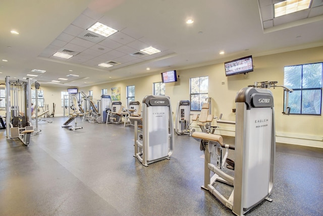 workout area with a healthy amount of sunlight and a paneled ceiling