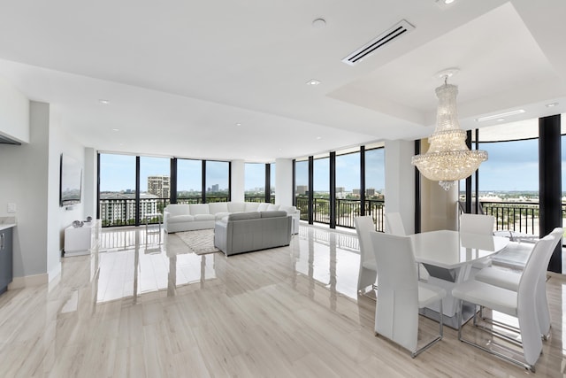 dining area featuring floor to ceiling windows, a notable chandelier, and light hardwood / wood-style floors