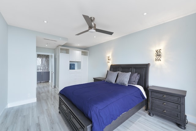 bedroom featuring light hardwood / wood-style floors, connected bathroom, and ceiling fan