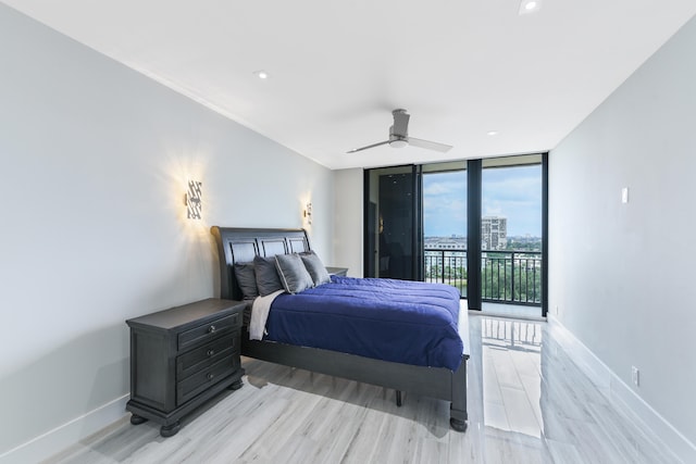 bedroom with access to outside, light hardwood / wood-style floors, ceiling fan, and expansive windows