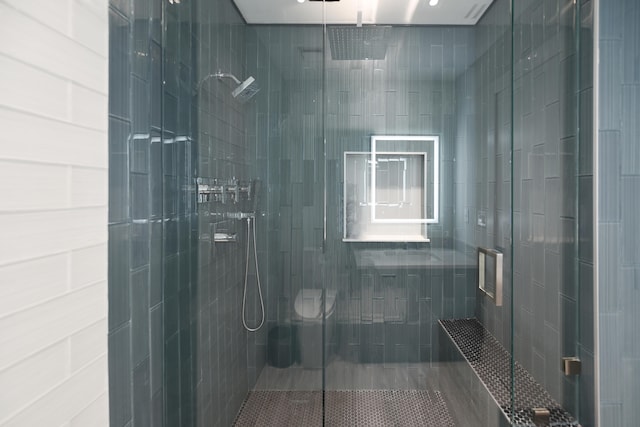 bathroom with a shower with door