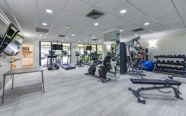 exercise room featuring carpet floors and a paneled ceiling