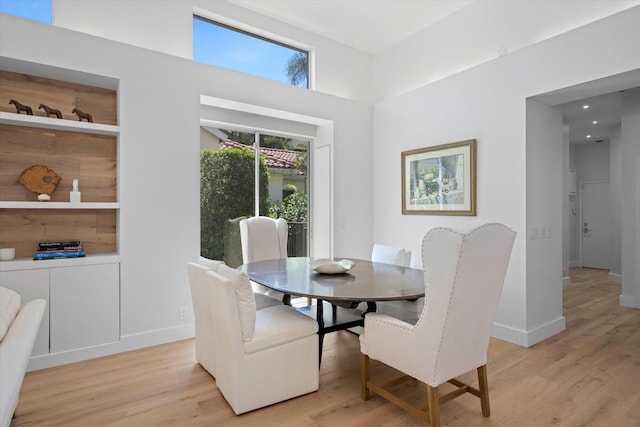 dining room featuring light hardwood / wood-style flooring and built in features