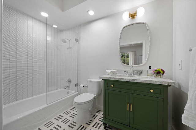 full bathroom featuring tiled shower / bath combo, vanity, tile floors, and toilet