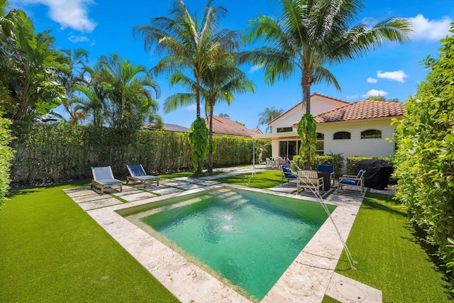 view of swimming pool with a lawn, grilling area, and a patio area