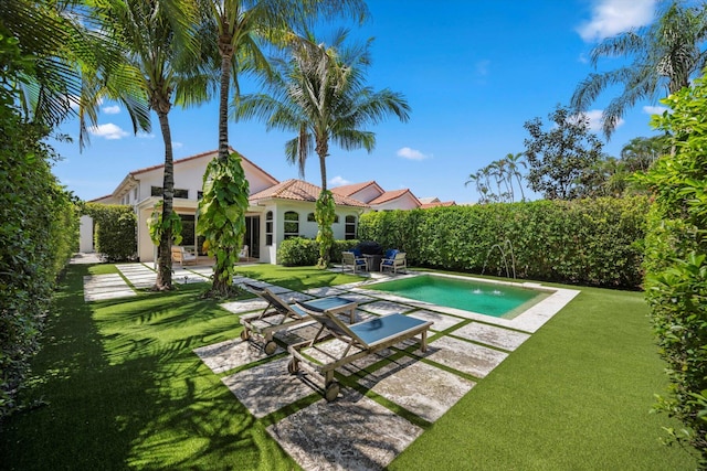 view of swimming pool with a patio area and a lawn