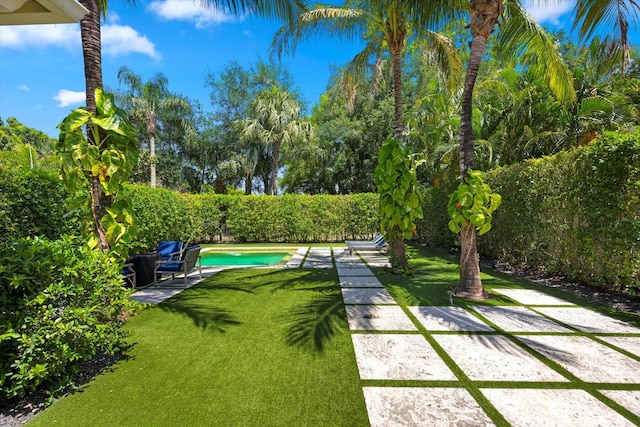 view of yard featuring a fenced in pool