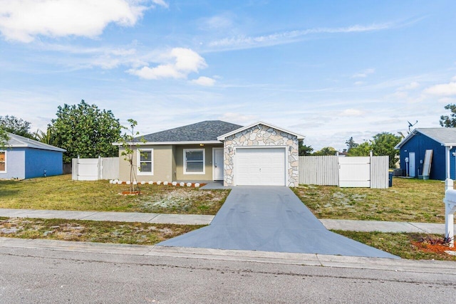 ranch-style house featuring a front lawn and a garage