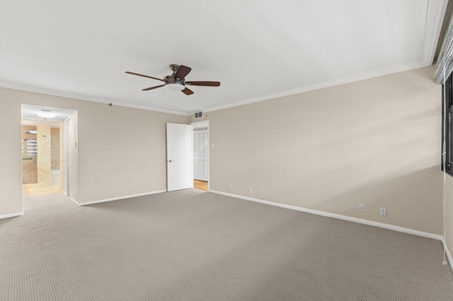 interior space with ornamental molding, carpet floors, ensuite bathroom, and ceiling fan