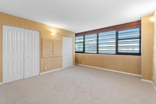 unfurnished bedroom with light carpet