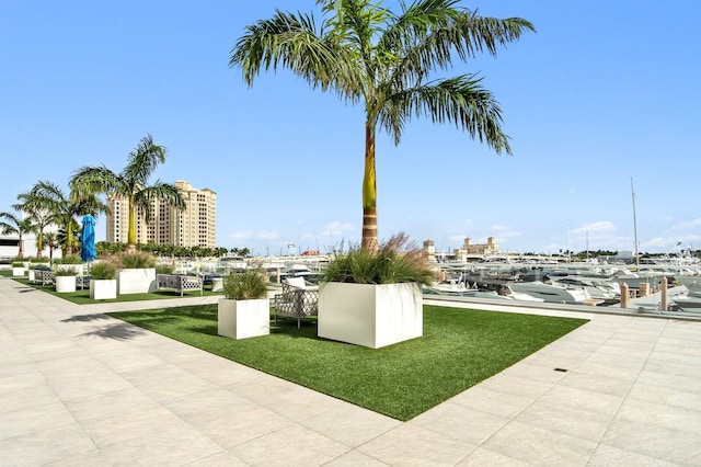 view of property's community featuring a water view and a yard