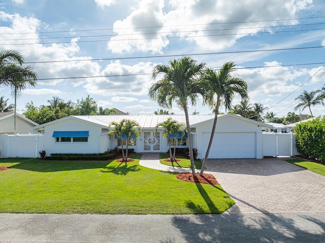 single story home with a garage and a front lawn