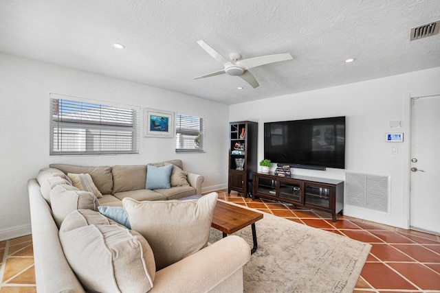 living room featuring tile patterned flooring, a textured ceiling, and ceiling fan