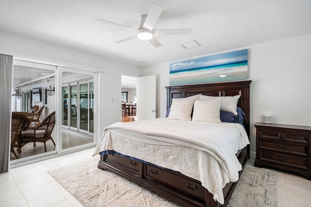 bedroom with light tile patterned flooring, a textured ceiling, access to exterior, and ceiling fan