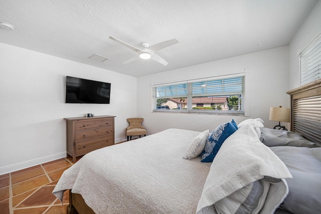 tiled bedroom featuring ceiling fan