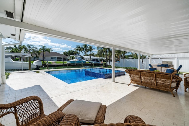 view of pool featuring an in ground hot tub, outdoor lounge area, and a patio area