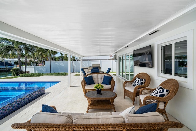 view of patio / terrace featuring a fenced in pool and an outdoor living space