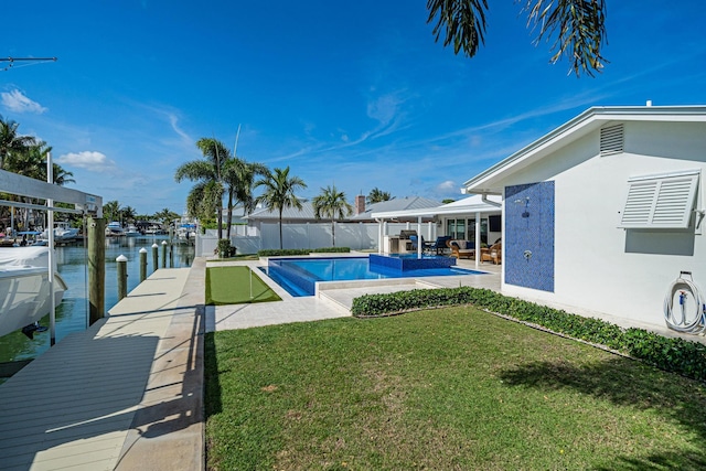 view of swimming pool with a patio, a jacuzzi, a yard, a boat dock, and a water view