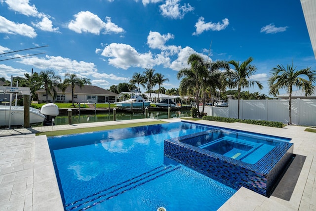 view of swimming pool featuring an in ground hot tub and a water view