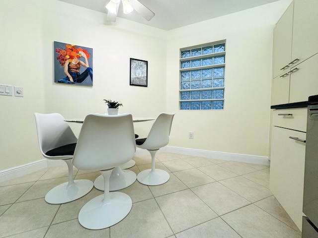 tiled dining space with ceiling fan