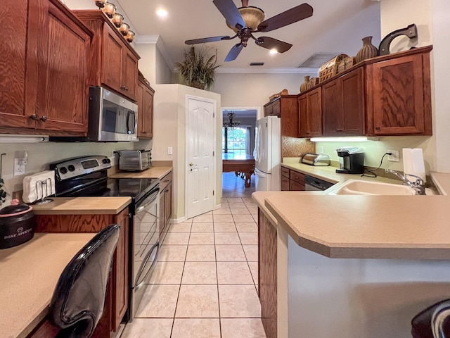 kitchen featuring crown molding, appliances with stainless steel finishes, light tile floors, sink, and ceiling fan