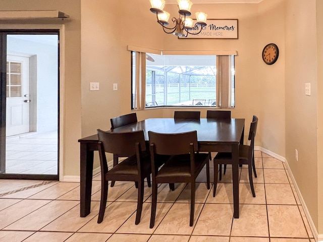 tiled dining area featuring a chandelier and ornamental molding