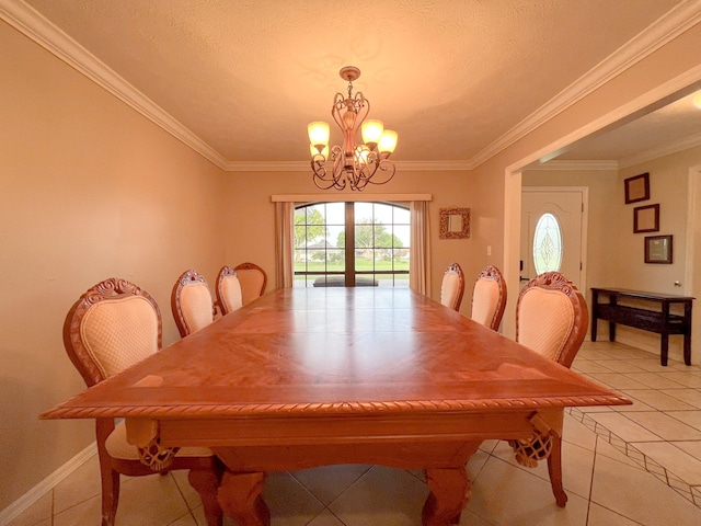 tiled dining space featuring crown molding and an inviting chandelier