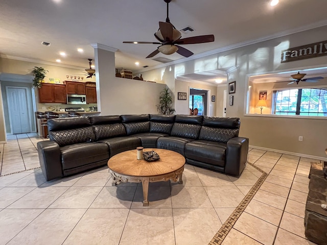 tiled living room with ceiling fan and ornamental molding