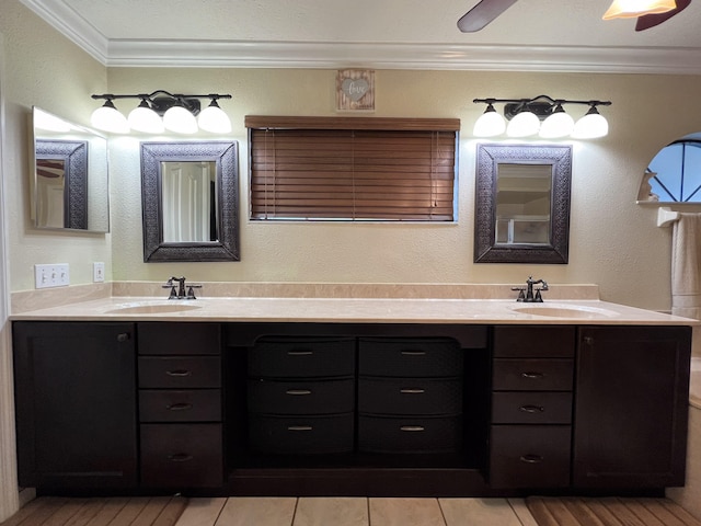 bathroom with ceiling fan, crown molding, and double vanity