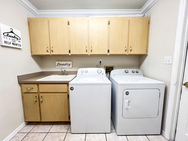 washroom with cabinets, sink, independent washer and dryer, and ornamental molding