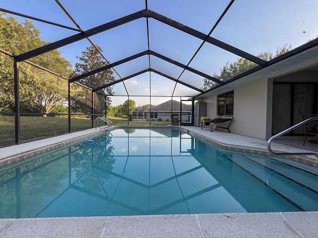 view of pool featuring a patio and glass enclosure