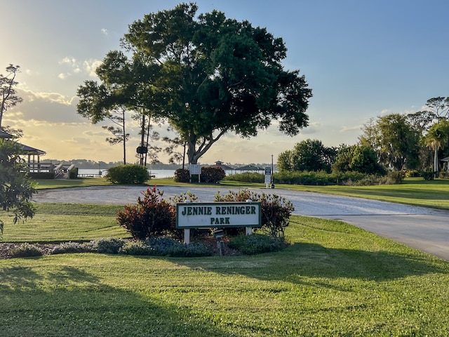 community / neighborhood sign with a yard