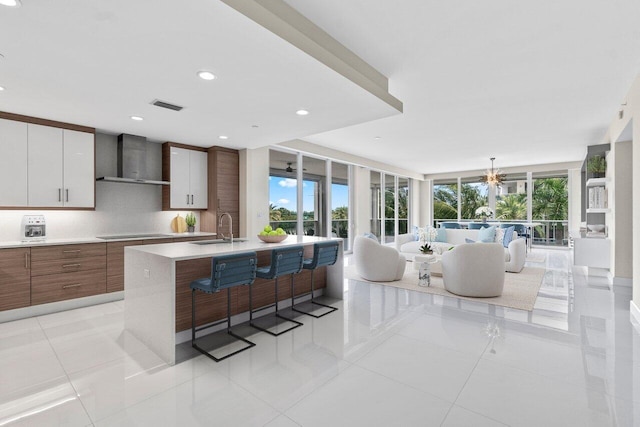 2720 Donald Ross Rd Unit 301, Palm Beach Gardens, FL 33410 - kitchen with a sink, light countertops, wall chimney exhaust hood, and modern cabinets