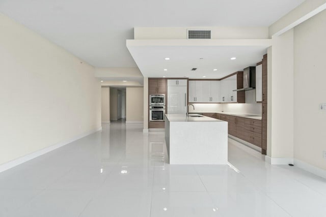 2720 Donald Ross Rd Unit 301, Palm Beach Gardens, FL 33410 - kitchen featuring visible vents, modern cabinets, wall chimney exhaust hood, stainless steel appliances, and a sink