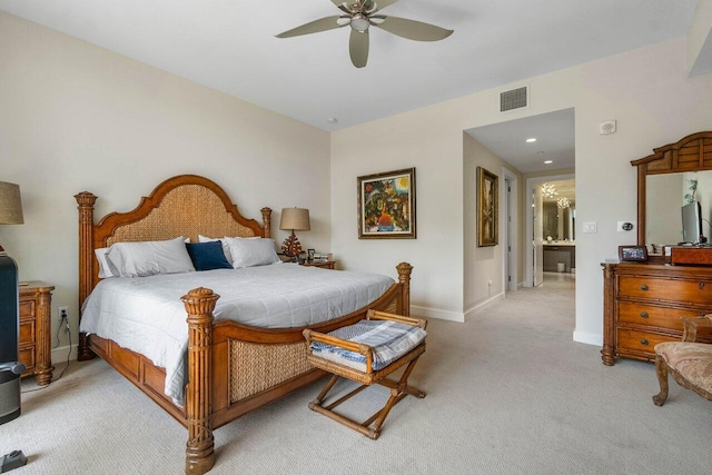 bedroom featuring ceiling fan, ensuite bath, and light carpet