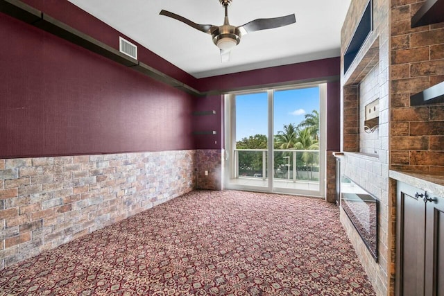2720 Donald Ross Rd Unit 301, Palm Beach Gardens, FL 33410 - empty room with visible vents, ceiling fan, a fireplace, and carpet