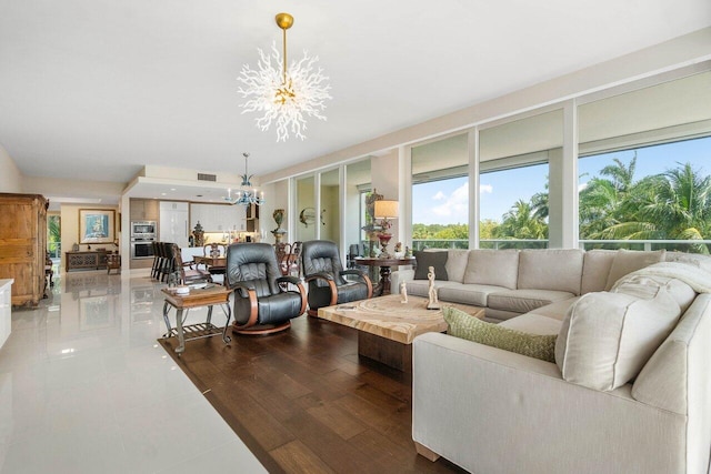 living room with hardwood / wood-style floors and an inviting chandelier