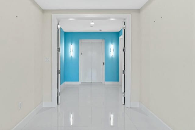 2720 Donald Ross Rd Unit 301, Palm Beach Gardens, FL 33410 - hallway featuring light tile patterned floors, baseboards, and elevator